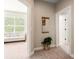 Neutral hallway showcasing a decorative mirror, a nearby sitting room, and entry to other rooms at 3519 Heards Ferry Dr, Tampa, FL 33618