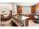 Spacious kitchen with granite countertops, wooden cabinets, stainless steel appliances, and a breakfast bar at 3519 Heards Ferry Dr, Tampa, FL 33618