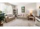 Bright living room with neutral-toned sofas, decorative shelving, and ample natural light at 3519 Heards Ferry Dr, Tampa, FL 33618