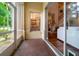 Screened patio with brick flooring, sliding glass doors and access to an indoor living space at 3519 Heards Ferry Dr, Tampa, FL 33618