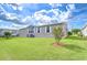 Home's exterior showcasing well-maintained lawn, landscaping and neighboring homes at 37526 New Horizons Blvd, Zephyrhills, FL 33541