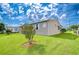 Spacious backyard featuring lush green lawn and well-kept landscaping around the home at 37526 New Horizons Blvd, Zephyrhills, FL 33541
