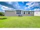 Spacious backyard featuring lush green lawn, well-kept landscaping, and tidy exteriors at 37526 New Horizons Blvd, Zephyrhills, FL 33541