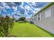 Spacious backyard features lush green lawn and beautiful landscaping around the perimeter of the property at 37526 New Horizons Blvd, Zephyrhills, FL 33541