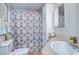 Clean bathroom featuring a toilet, sink, and shower with a charming floral curtain at 37526 New Horizons Blvd, Zephyrhills, FL 33541