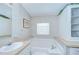 Bathroom featuring a large garden tub and storage cabinets at 37526 New Horizons Blvd, Zephyrhills, FL 33541