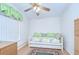 This bedroom features light-colored wooden floors, matching dressers, and a colorful daybed at 37526 New Horizons Blvd, Zephyrhills, FL 33541