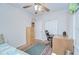 Bedroom with a work area and desk with chair, and a large rug under the daybed at 37526 New Horizons Blvd, Zephyrhills, FL 33541