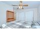Bedroom featuring ceiling fan, standard closets and a window for natural light at 37526 New Horizons Blvd, Zephyrhills, FL 33541