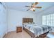 Bedroom featuring ceiling fan, laminate flooring, standard closet and a window for natural light at 37526 New Horizons Blvd, Zephyrhills, FL 33541