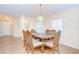 Cozy dining room features wood flooring, chandelier, and ample natural light at 37526 New Horizons Blvd, Zephyrhills, FL 33541