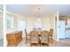 Well-lit dining area with chandelier, hardwood floors, and seating for six at 37526 New Horizons Blvd, Zephyrhills, FL 33541