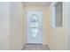 The front door with decorative glass insert welcomes you into this charming home at 37526 New Horizons Blvd, Zephyrhills, FL 33541