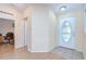Clean entryway with decorative front door leads into a naturally lit home at 37526 New Horizons Blvd, Zephyrhills, FL 33541