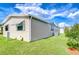 Home's exterior showcasing well-maintained siding, manicured lawn and efficient AC unit at 37526 New Horizons Blvd, Zephyrhills, FL 33541