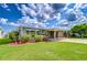 Inviting home with covered parking and colorful, professionally landscaped yard at 37526 New Horizons Blvd, Zephyrhills, FL 33541