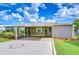Inviting single-story home with covered parking and an enclosed porch for added living space at 37526 New Horizons Blvd, Zephyrhills, FL 33541