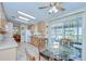 Open kitchen has light wood cabinets, stainless appliances, and connects to a breakfast nook at 37526 New Horizons Blvd, Zephyrhills, FL 33541