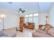Inviting living room with cozy brown sofas, lots of natural light, and a ceiling fan at 37526 New Horizons Blvd, Zephyrhills, FL 33541