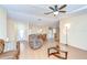 Living room area features a recliner, brown sofas, and open access to the dining room and kitchen at 37526 New Horizons Blvd, Zephyrhills, FL 33541