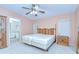 Bedroom with ceiling fan, standard closets, and an en-suite bathroom at 37526 New Horizons Blvd, Zephyrhills, FL 33541