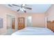 Bedroom with ceiling fan, standard closets, and an en-suite bathroom at 37526 New Horizons Blvd, Zephyrhills, FL 33541