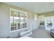 Covered patio with a sitting area and sliding glass door to the home's interior at 37526 New Horizons Blvd, Zephyrhills, FL 33541