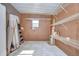 Spacious storage room featuring white metal racks, a window, and concrete flooring at 37526 New Horizons Blvd, Zephyrhills, FL 33541