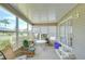 Enclosed sunroom with large windows, and a variety of seating options at 37526 New Horizons Blvd, Zephyrhills, FL 33541
