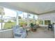 Cozy sunroom with a seating area that overlooks a lush yard at 37526 New Horizons Blvd, Zephyrhills, FL 33541