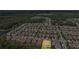 This aerial shows the property with a pool in a large residential community with nearby trees and a lake at 3999 Burdick Loop, Odessa, FL 33556
