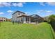 This home features a lush backyard with a screened-in pool and a fenced yard, perfect for outdoor entertaining at 3999 Burdick Loop, Odessa, FL 33556