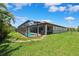 Enjoy outdoor living with this home's screened pool, green lawn, and mature trees at 3999 Burdick Loop, Odessa, FL 33556