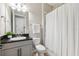 Bathroom with white vanity, shower curtain, and decorative elements at 3999 Burdick Loop, Odessa, FL 33556