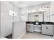 Spa-like bathroom featuring a glass enclosed shower, double vanity with a granite countertop, and modern lighting at 3999 Burdick Loop, Odessa, FL 33556