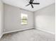 Simple carpeted bedroom with a ceiling fan and a window at 3999 Burdick Loop, Odessa, FL 33556