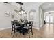 Dining room featuring a modern chandelier, a black dining table, and stylish decor at 3999 Burdick Loop, Odessa, FL 33556