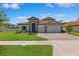 Beautiful two-story home with a well-manicured lawn, stone accents, and a two-car garage at 3999 Burdick Loop, Odessa, FL 33556