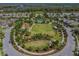 Overhead view of the community's expansive green space, complete with a pool, cabanas, and walking paths at 3999 Burdick Loop, Odessa, FL 33556