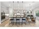Modern kitchen features gray cabinets, an island with seating, stainless steel appliances, and stylish pendant lights at 3999 Burdick Loop, Odessa, FL 33556