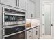 Modern kitchen features stainless steel appliances, white cabinets, and sleek black countertops at 3999 Burdick Loop, Odessa, FL 33556