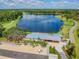 Aerial view of a lakefront amenity center with an open porch, providing recreational opportunities for community residents at 3999 Burdick Loop, Odessa, FL 33556