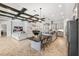 Open-concept living space boasts herringbone floors, island seating, and a decorative beamed ceiling at 3999 Burdick Loop, Odessa, FL 33556