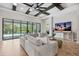 Comfortable living room with coffered ceilings, large sofa, and a view of the pool area at 3999 Burdick Loop, Odessa, FL 33556