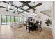 Bright living room with coffered ceilings, a ceiling fan, and sliding glass doors to an outdoor pool area at 3999 Burdick Loop, Odessa, FL 33556