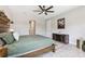 A beautifully staged main bedroom with herringbone floors, stylish furniture, and elegant decor at 3999 Burdick Loop, Odessa, FL 33556