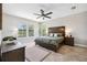 Spacious main bedroom features a wood accent wall, rustic furniture, herringbone floors, and natural light at 3999 Burdick Loop, Odessa, FL 33556