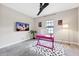 Bright home office with a unique desk and stylish decor, lit by a modern floor lamp at 3999 Burdick Loop, Odessa, FL 33556