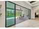 Covered outdoor patio with a dining area offers seamless access to the screened pool at 3999 Burdick Loop, Odessa, FL 33556