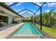 A screened pool features a spa and expansive deck for relaxing and entertaining at 3999 Burdick Loop, Odessa, FL 33556